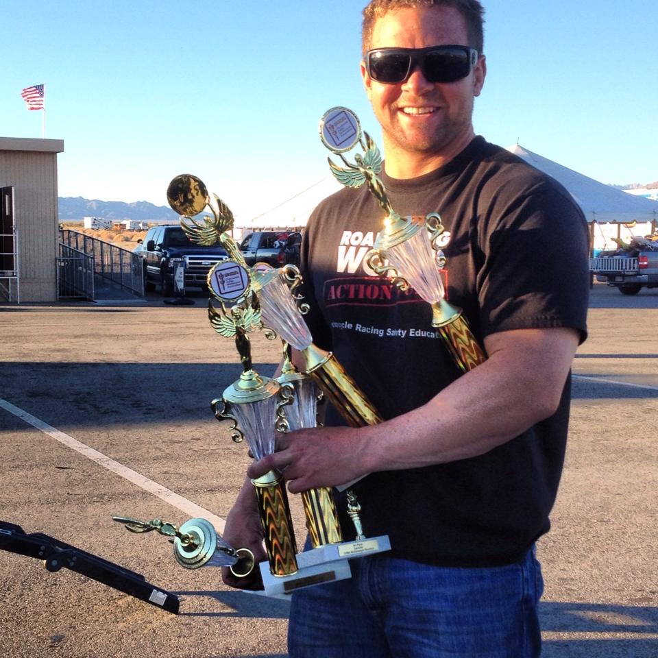 Brian Short holding multiple race trophies after a winning weekend at the track